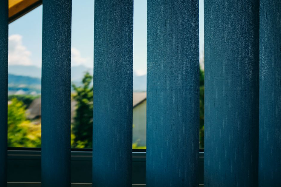 Sunlight filtering through modern custom blinds and drapery